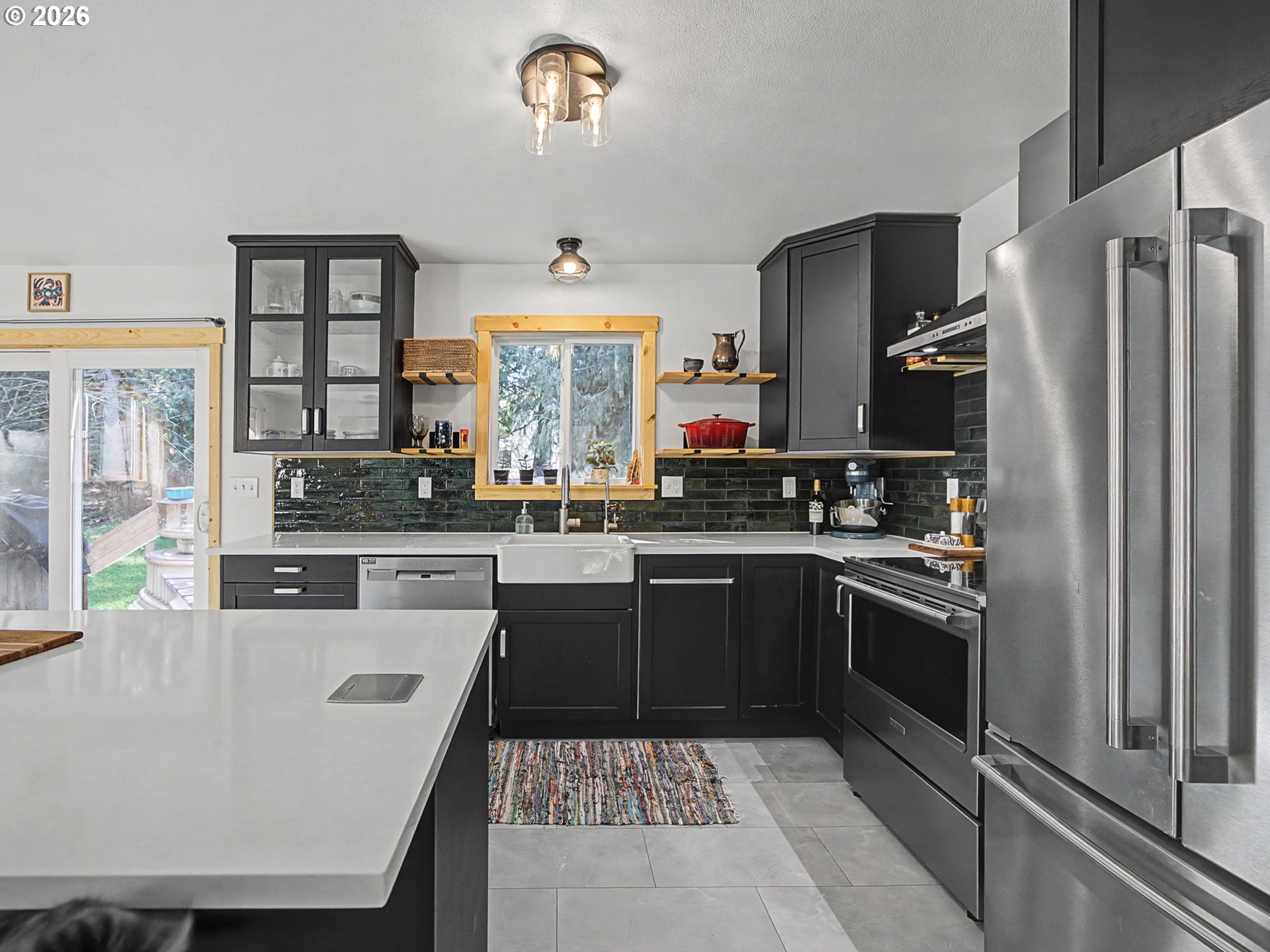 36036 Southeast Gunderson Road Sandy, OR 97055 - Photo 13 of 48 a kitchen with stainless steel appliances granite countertop a sink stove refrigerator and cabinets