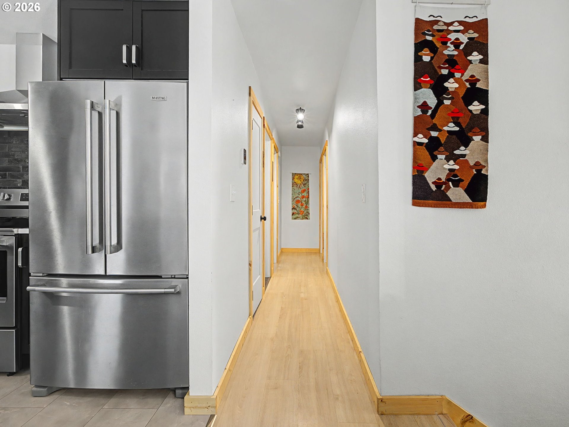 36036 Southeast Gunderson Road Sandy, OR 97055 - Photo 15 of 48 a view of a refrigerator in kitchen and an empty room