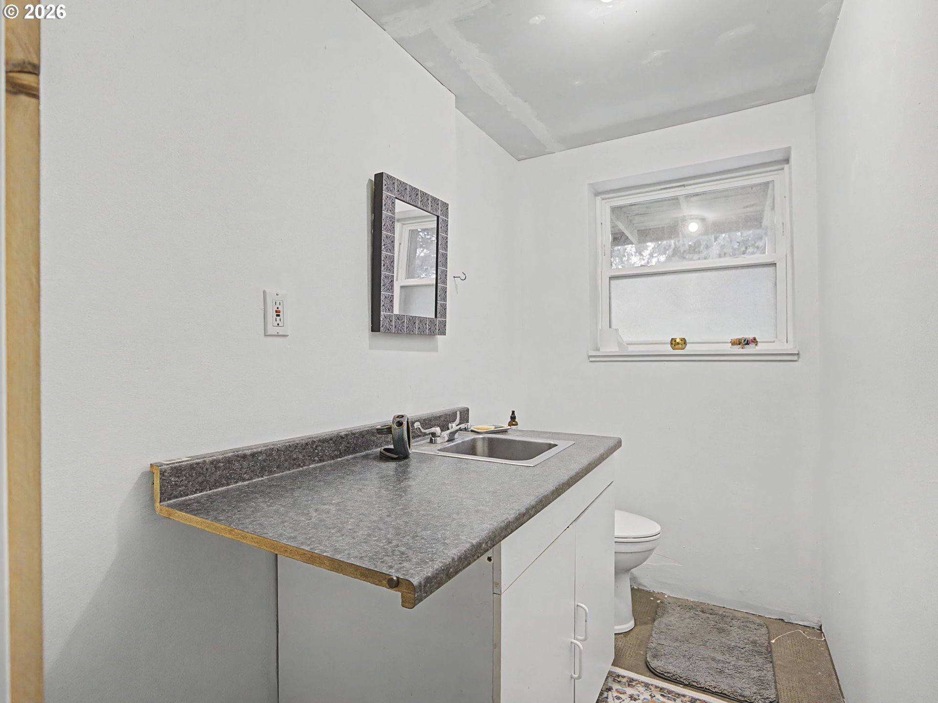 36036 Southeast Gunderson Road Sandy, OR 97055 - Photo 31 of 48 a bathroom with a granite countertop sink and a toilet