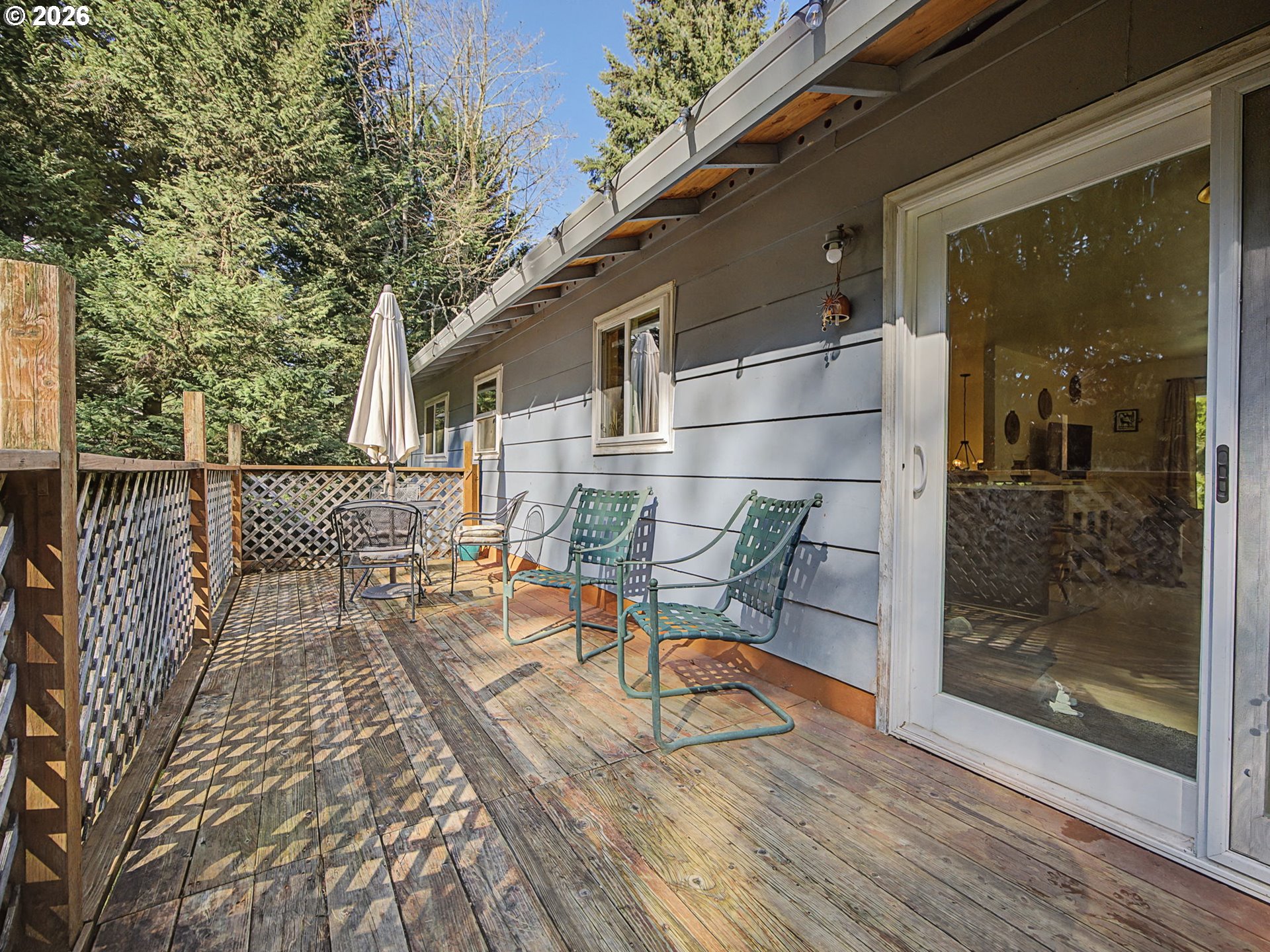 36036 Southeast Gunderson Road Sandy, OR 97055 - Photo 35 of 48 a view of a patio with table and chairs with wooden floor and fence