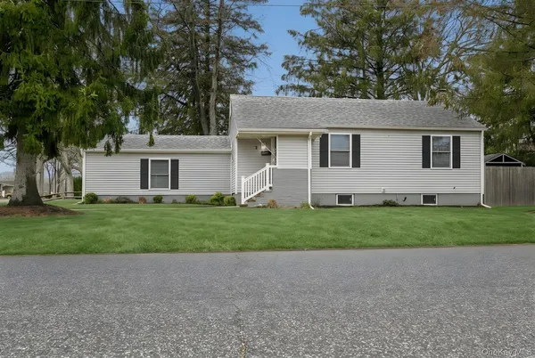 a front view of house with yard and green space