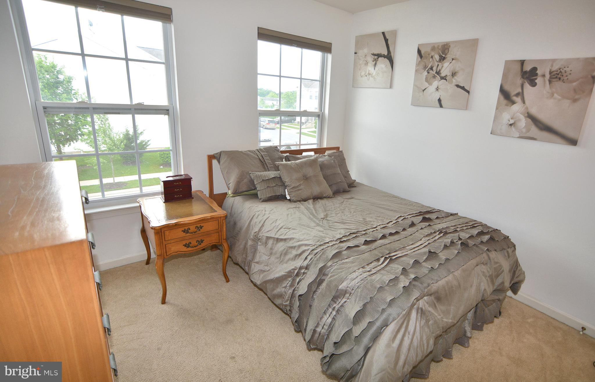 9722 Langley Road Baltimore, MD 21220 - Photo 15 of 30 a bedroom with a bed and a large window