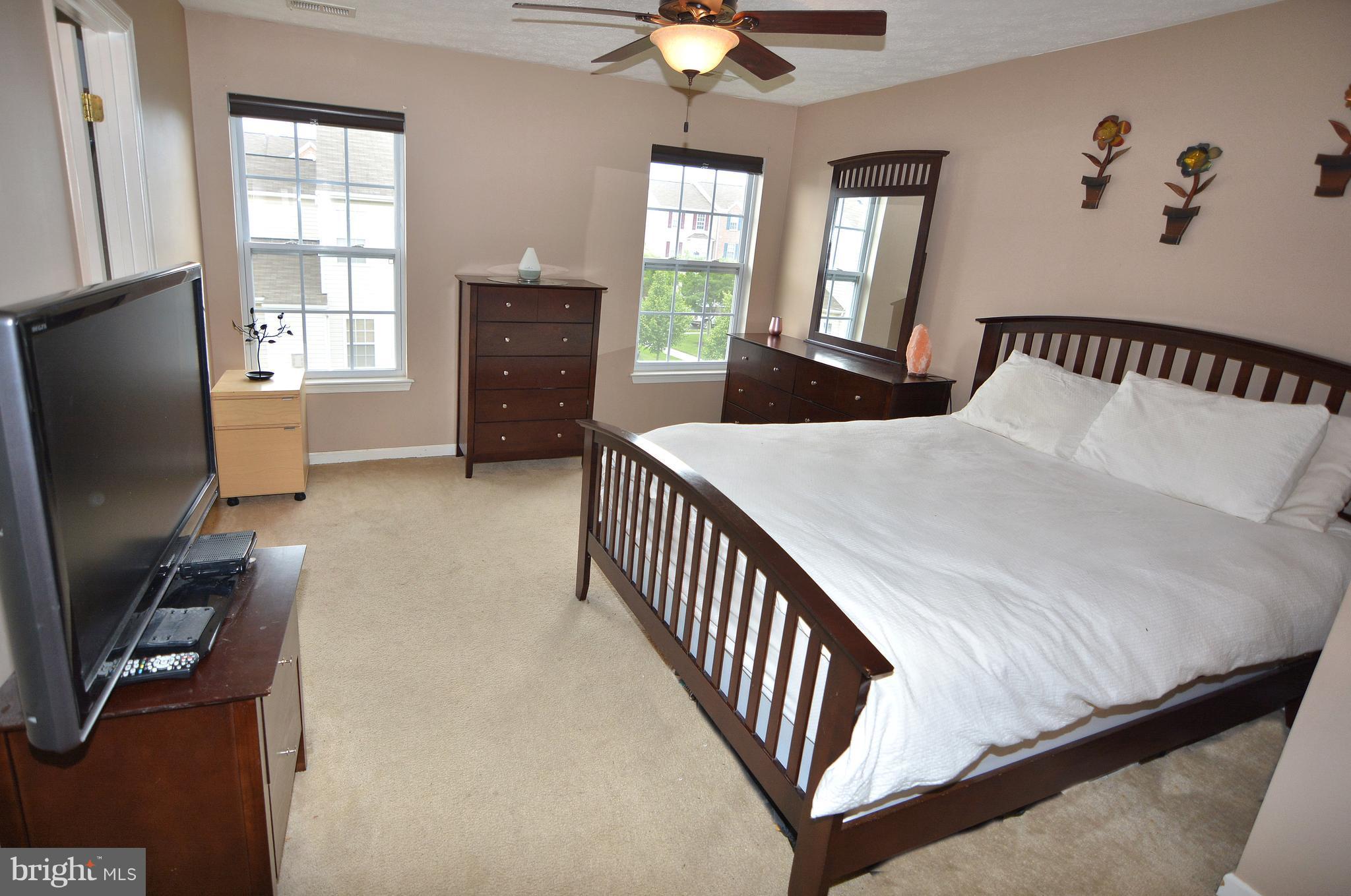9722 Langley Road Baltimore, MD 21220 - Photo 3 of 30 a bedroom with a bed and flat screen tv