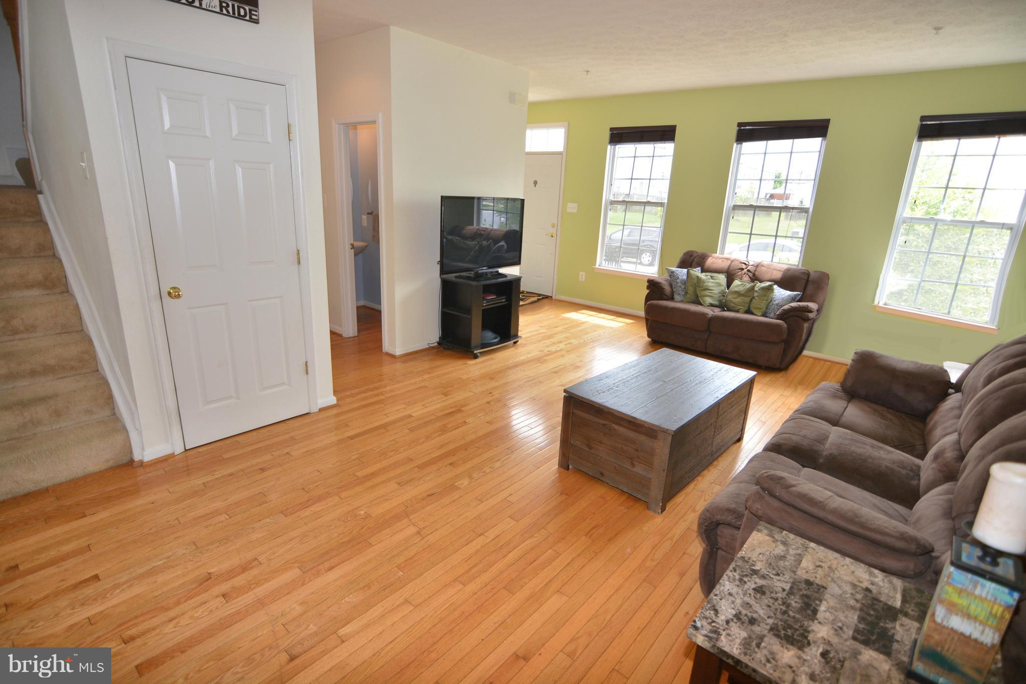 9722 Langley Road Baltimore, MD 21220 - Photo 26 of 30 a living room with furniture and wooden floor