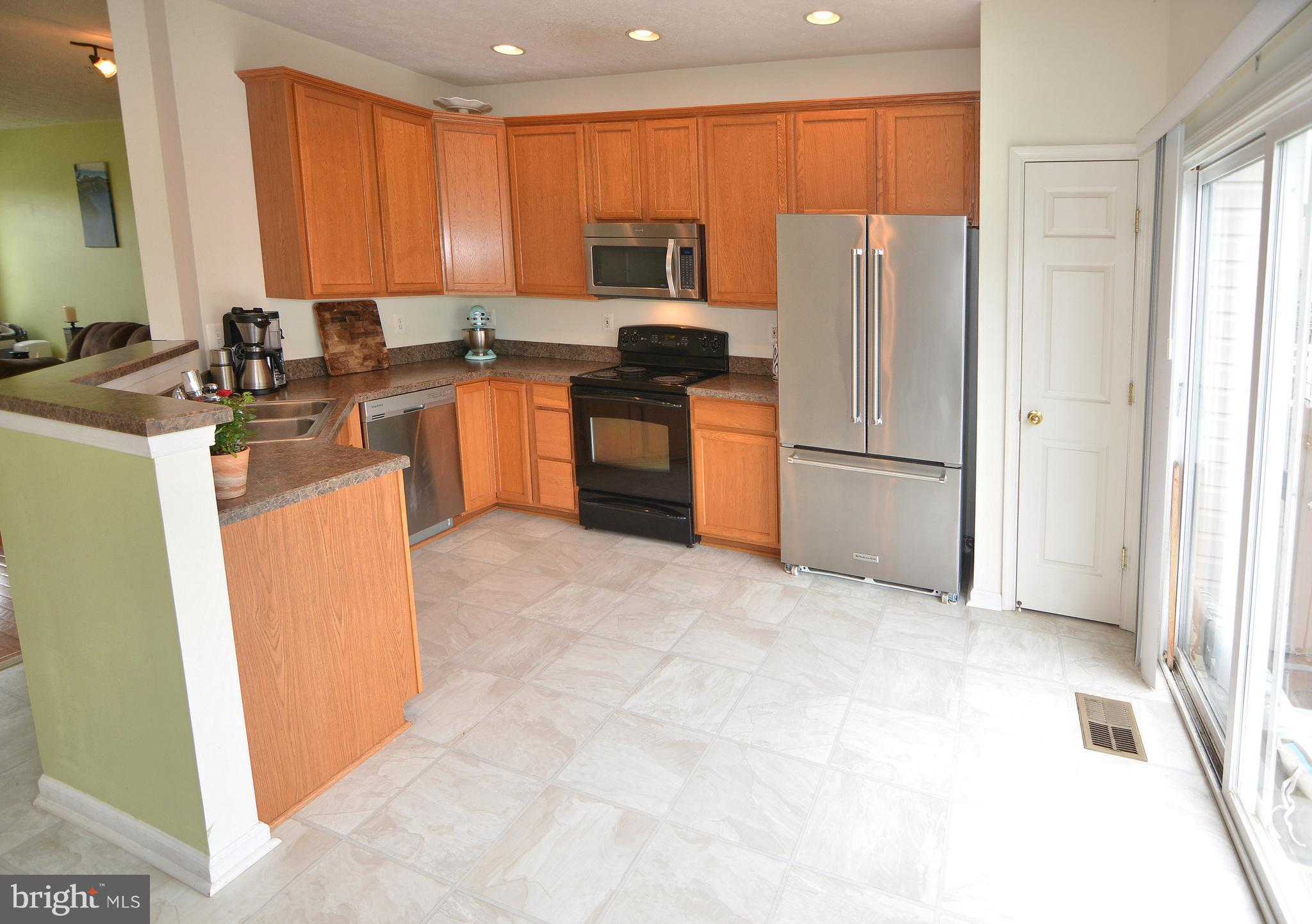 9722 Langley Road Baltimore, MD 21220 - Photo 6 of 30 a kitchen with granite countertop a refrigerator stove top oven and sink
