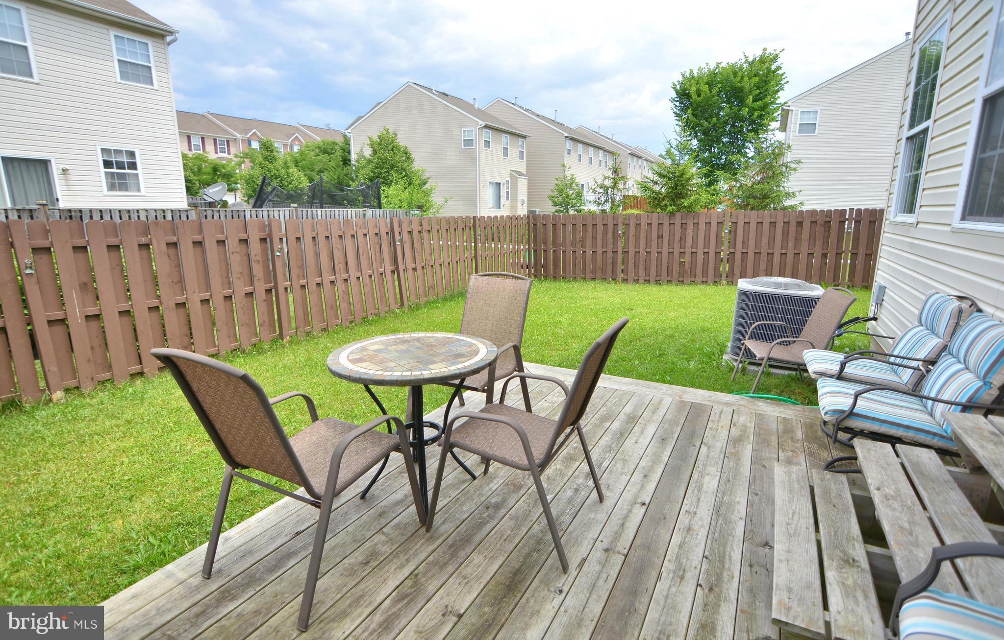9722 Langley Road Baltimore, MD 21220 - Photo 8 of 30 a view of a chairs with a table in the backyard