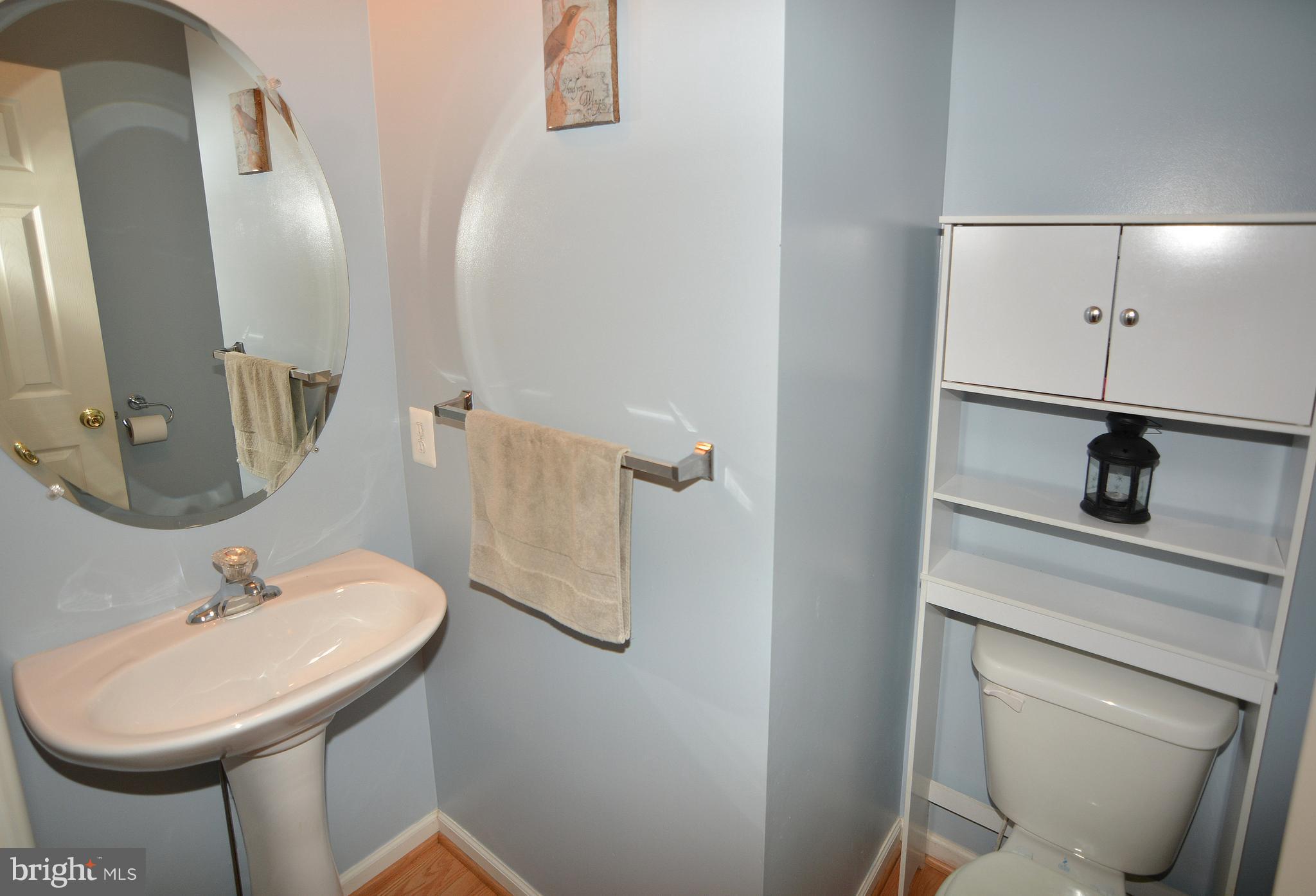 9722 Langley Road Baltimore, MD 21220 - Photo 9 of 30 a bathroom with a sink a toilet and a mirror
