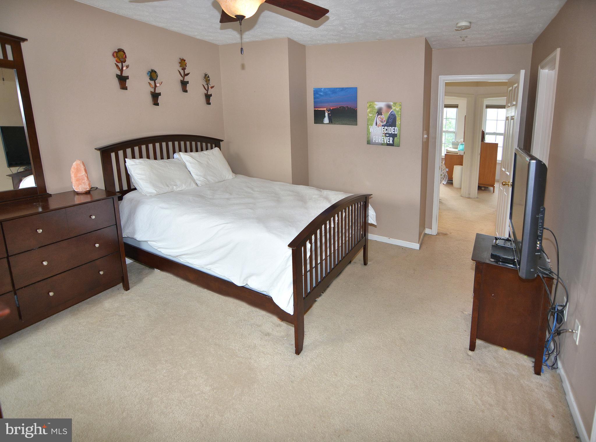 9722 Langley Road Baltimore, MD 21220 - Photo 10 of 30 a bed room with a bed and a television