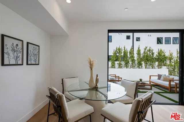 a dining room with furniture and a large window
