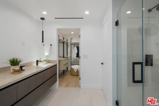 a bathroom with a double vanity sink mirror and toilet