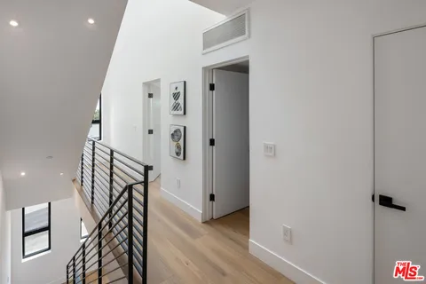 a very nice looking room with wooden floor and stairs