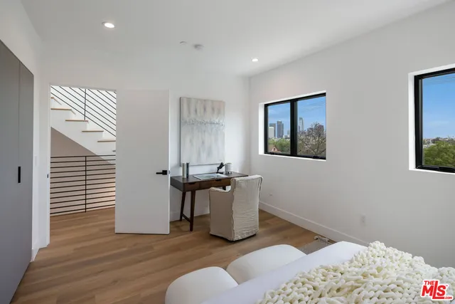 a bedroom with furniture and a window