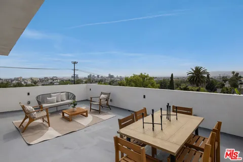 a terrace with outdoor seating and city view