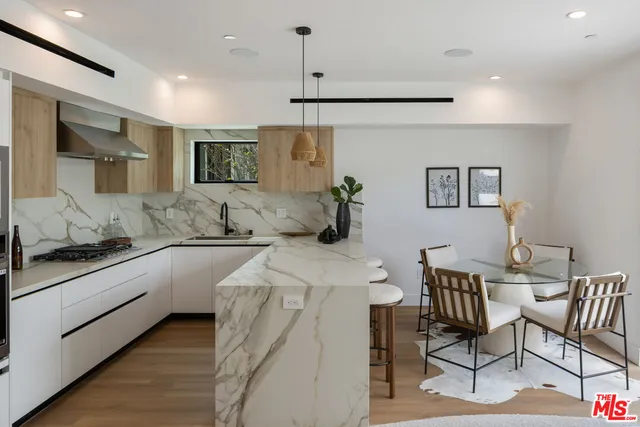 a kitchen with stainless steel appliances kitchen island granite countertop a sink and cabinets