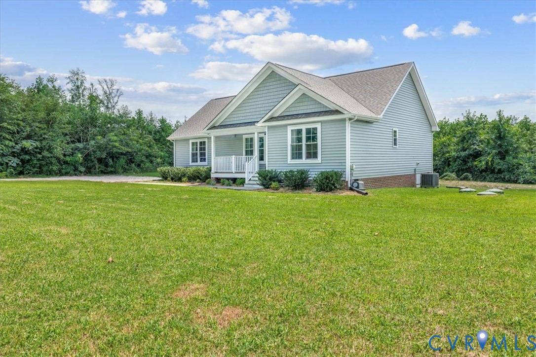 7341 Thweatt Drive Disputanta, VA 23842 - Photo 2 of 38 a view of a house next to a big yard and large trees