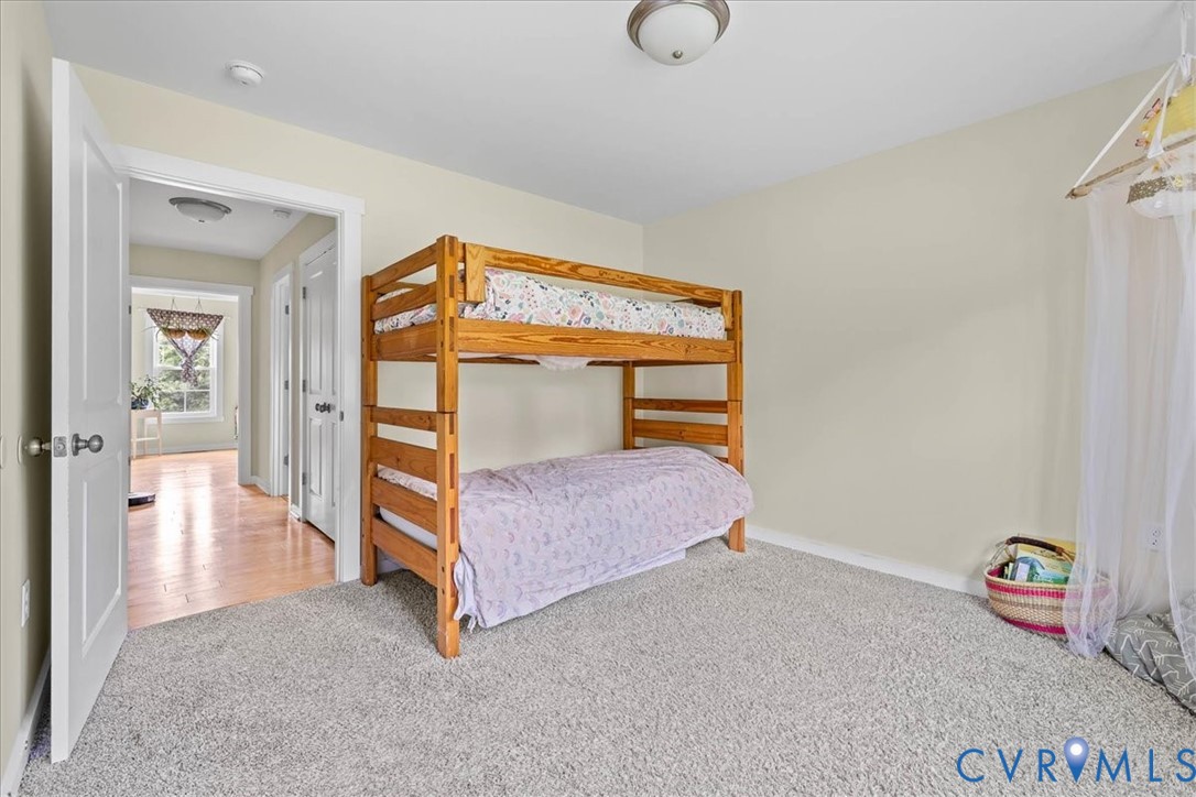 7341 Thweatt Drive Disputanta, VA 23842 - Photo 23 of 38 a bedroom with bed and a chandelier