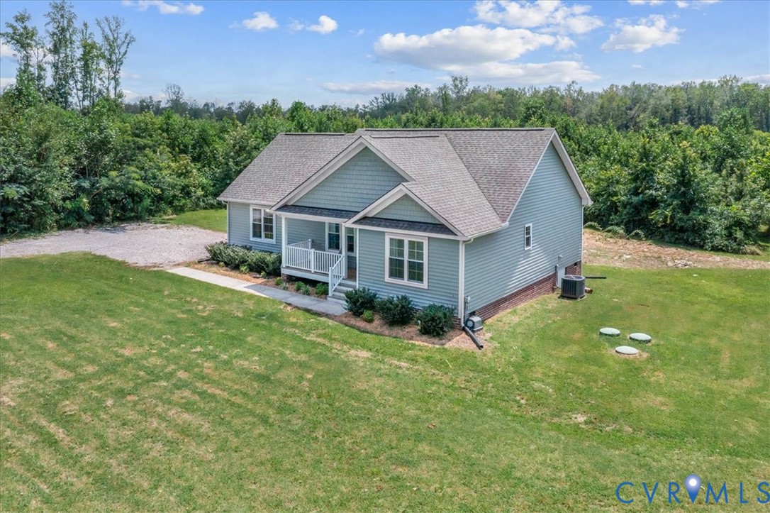 7341 Thweatt Drive Disputanta, VA 23842 - Photo 26 of 38 a aerial view of a house with a yard table and chairs
