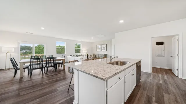 a view of dining table chairs and wooden floor
