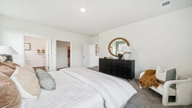 a bedroom with a bed and a mirror