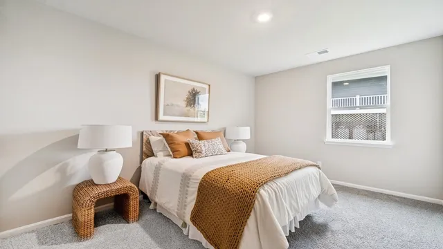 a bedroom with a bed and a painting on the wall