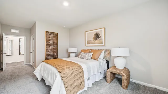 a bedroom with a bed and a painting on the wall