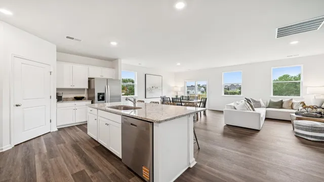 a open kitchen with center island and stainless steel appliances