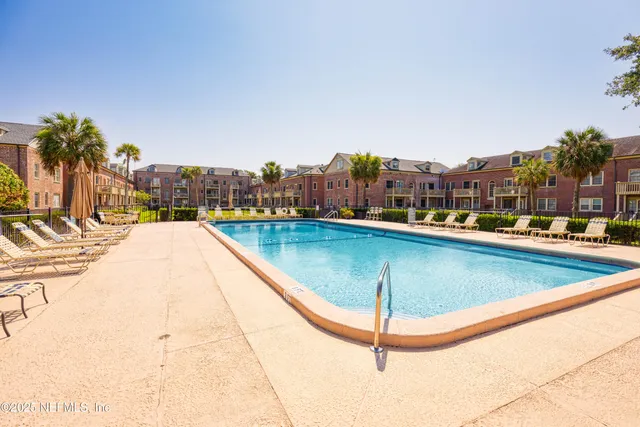 a swimming pool with outdoor seating and yard