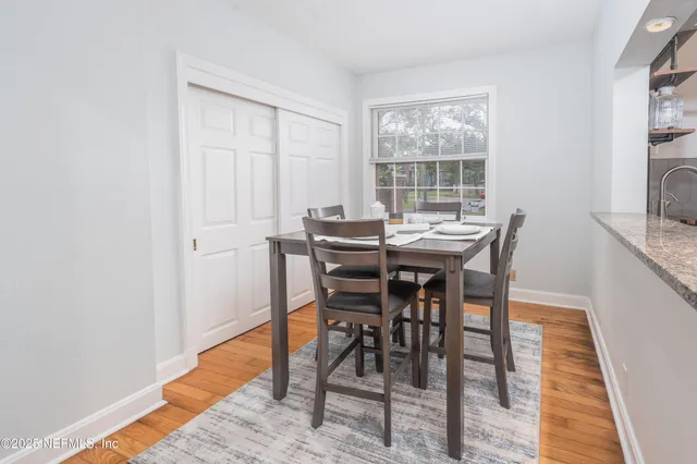 a view of a dining room with furniture and window