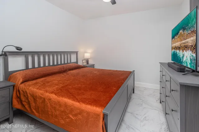 a bed sitting in a bedroom next to a window