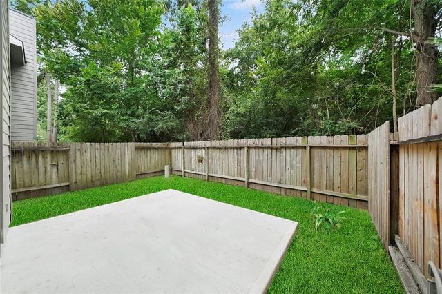 a view of a backyard with a small cabin and wooden fence