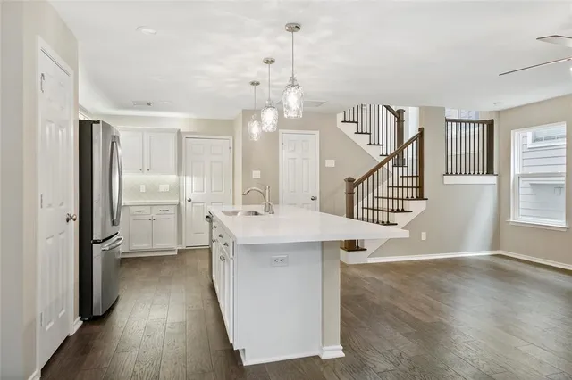 a kitchen view with stainless steel appliances a stove and a refrigerator