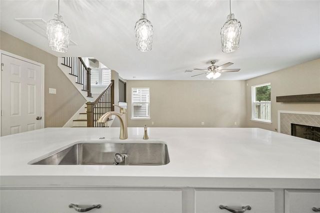 a view of a kitchen sink and chandelier