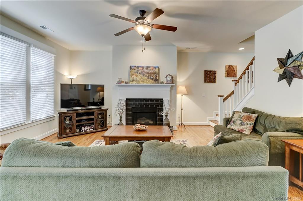 3422 Richard's Crossing Fort Mill, SC 29708 - Photo 24 of 48 a living room with furniture a flat screen tv and a fireplace