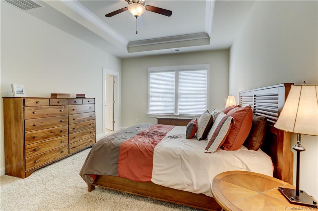 3422 Richard's Crossing Fort Mill, SC 29708 - Photo 26 of 48 a bedroom with a bed and a chandelier