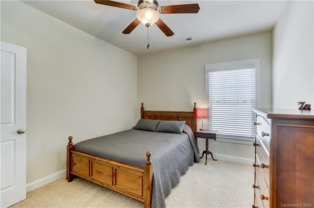 3422 Richard's Crossing Fort Mill, SC 29708 - Photo 38 of 48 a bedroom with a bed and a chandelier