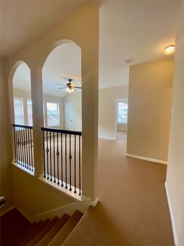 a view of a livingroom with a ceiling fan and window