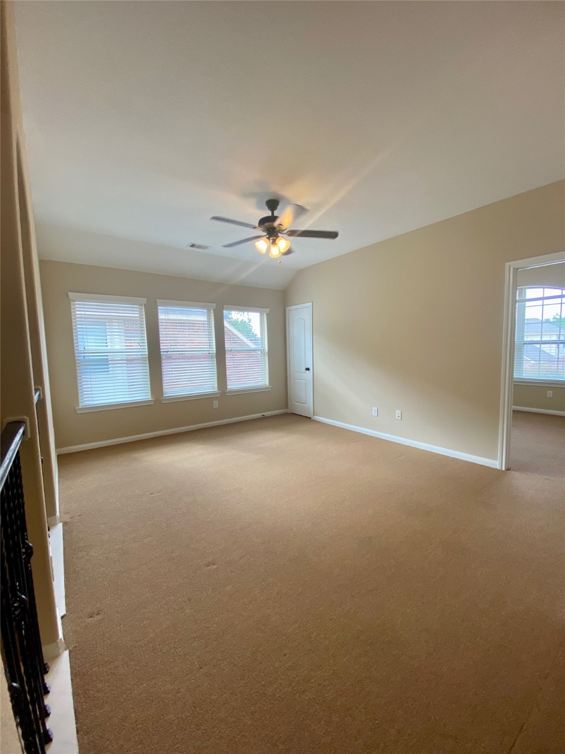 15 Sagamore Ridge Place The Woodlands, TX 77389 - Photo 25 of 39 an empty room with windows and chandelier fan