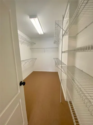 a view of a room with wooden floor and cabinet