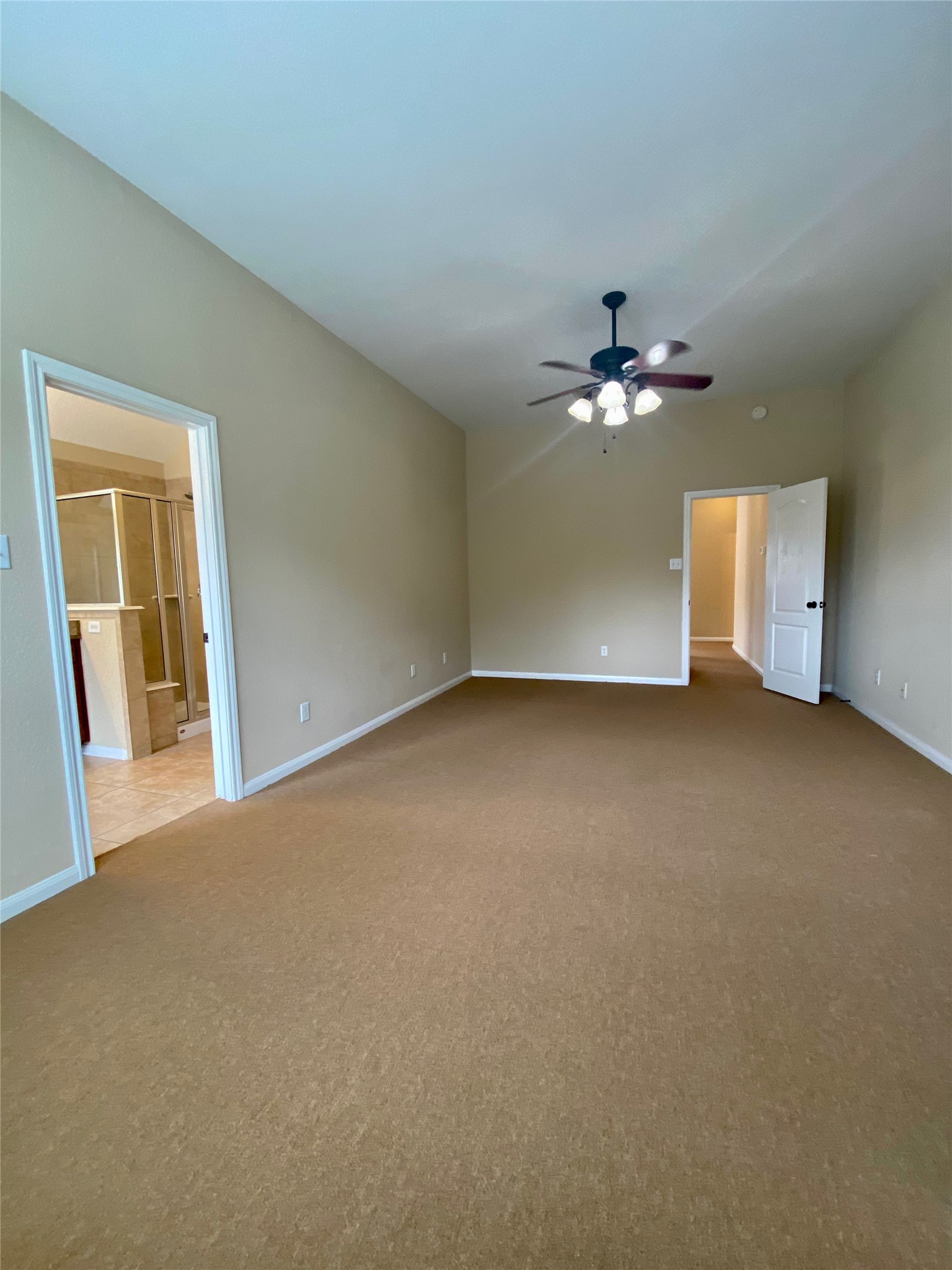 15 Sagamore Ridge Place The Woodlands, TX 77389 - Photo 33 of 39 a view of an empty room with a chandelier fan