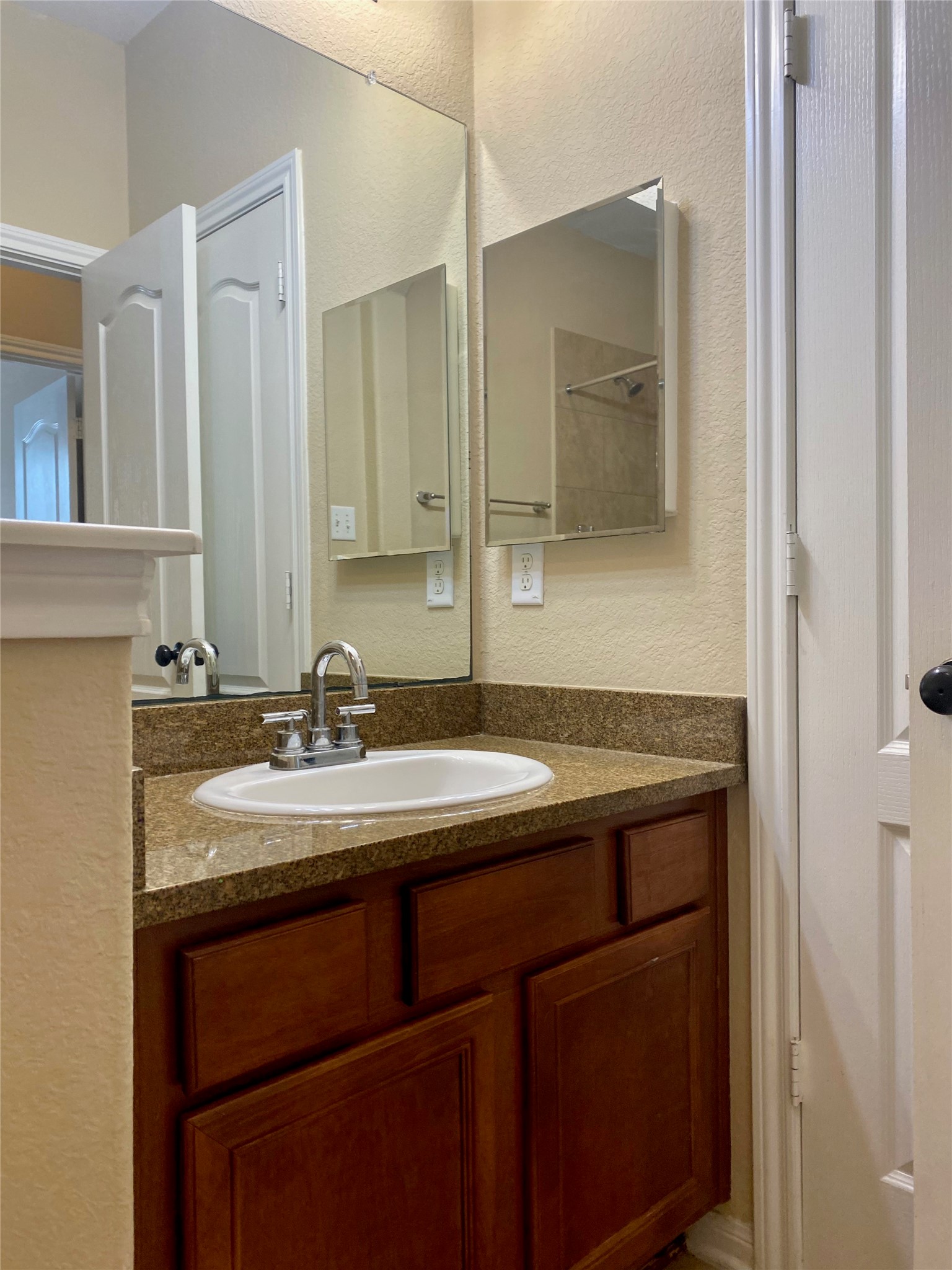 15 Sagamore Ridge Place The Woodlands, TX 77389 - Photo 7 of 39 a bathroom with a sink and a mirror