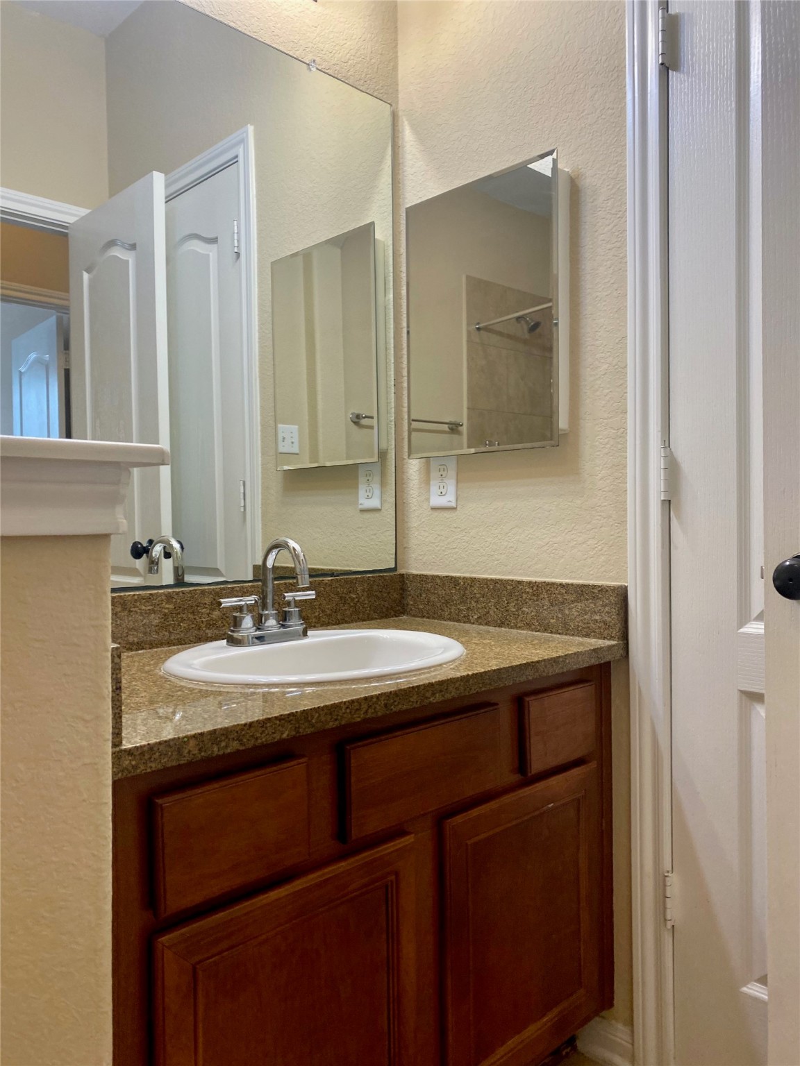 15 Sagamore Ridge Place The Woodlands, TX 77389 - Photo 7 of 39 a bathroom with a sink and a mirror