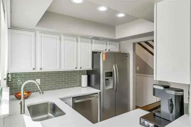 a kitchen with a refrigerator sink and stove