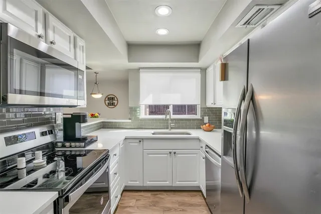 a kitchen with a stove a sink and a refrigerator