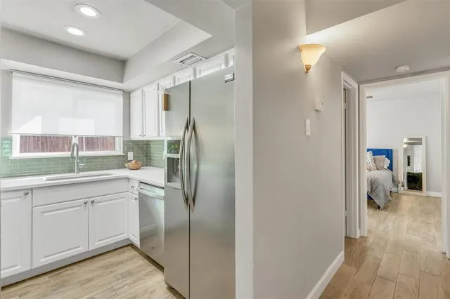 a kitchen with a refrigerator and a sink