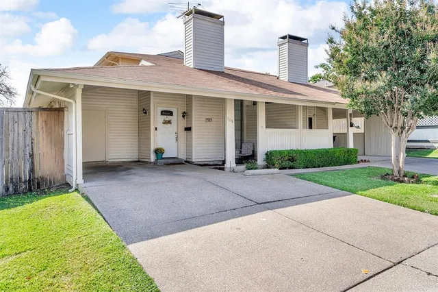 a front view of a house with a garden and plants