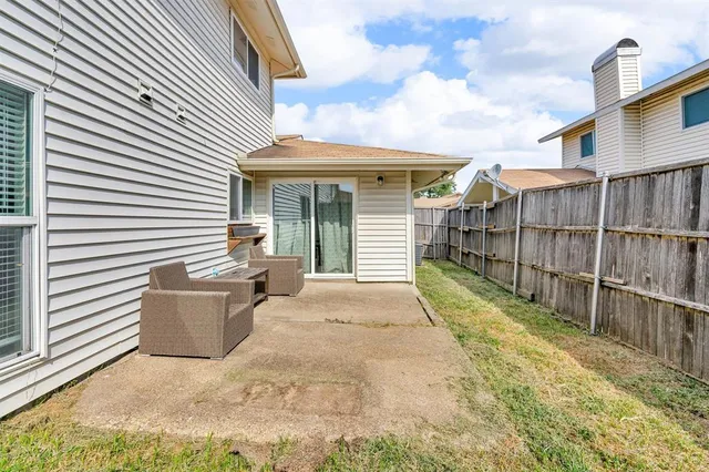 a view of a house with a wooden fence