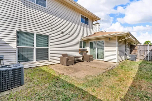 a view of a house with a yard and sitting area