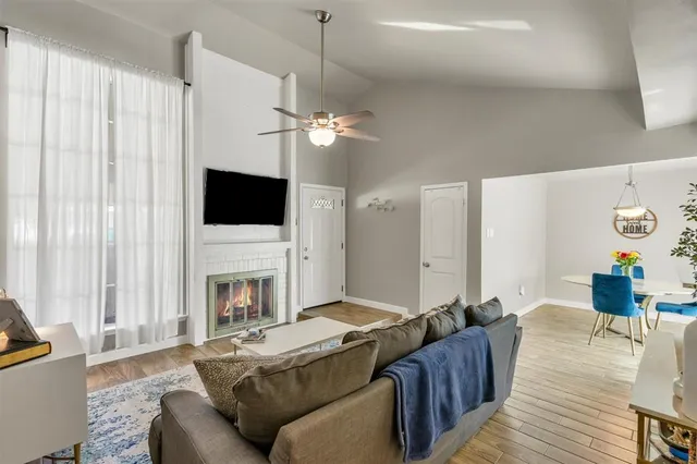 a living room with furniture a fireplace and a flat screen tv