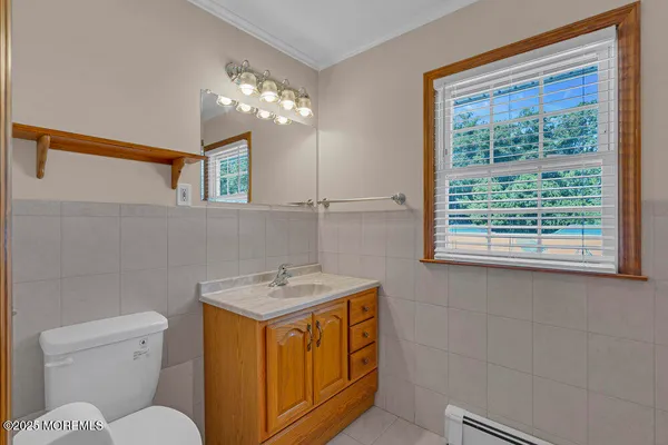a bathroom with a sink a toilet and a mirror