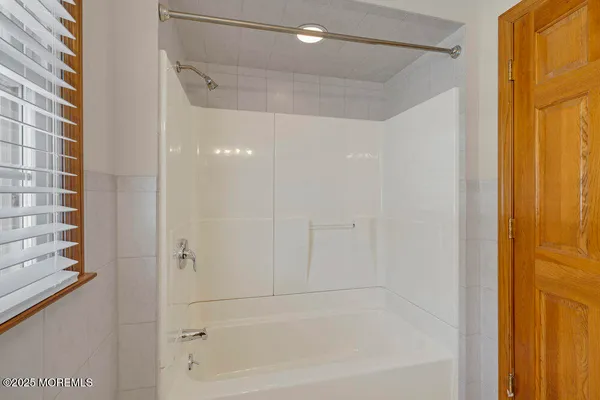 a bathroom with a shower and a bath tub